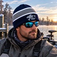 Man wearing blue and gray ShredFin Cold Front fishing beanie on a boat