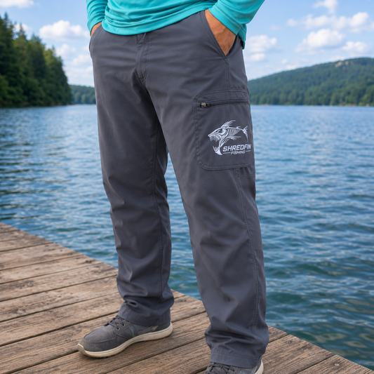 Man standing on lake dock wearing ShredFin Fishing pants.