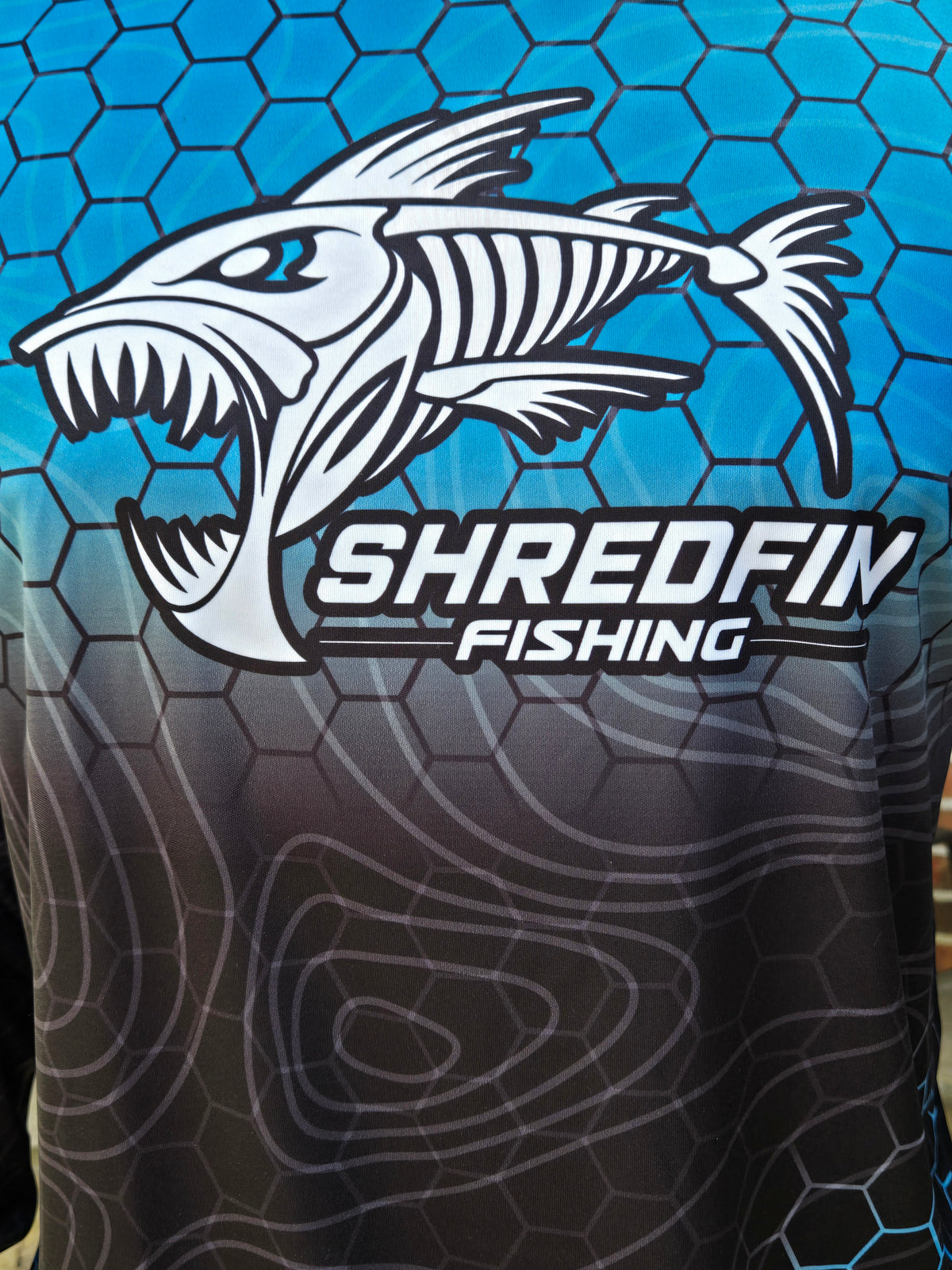 close up photo of chest of ShredFin HexCast Almafi Coast Fade performance shirt.