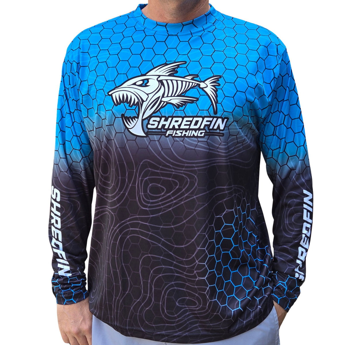 ShredFin HexCast Amalfi Coast Fade long sleeve performance fishing shirt with blue hex pattern, black topo fade, and UPF 50+ sun protection